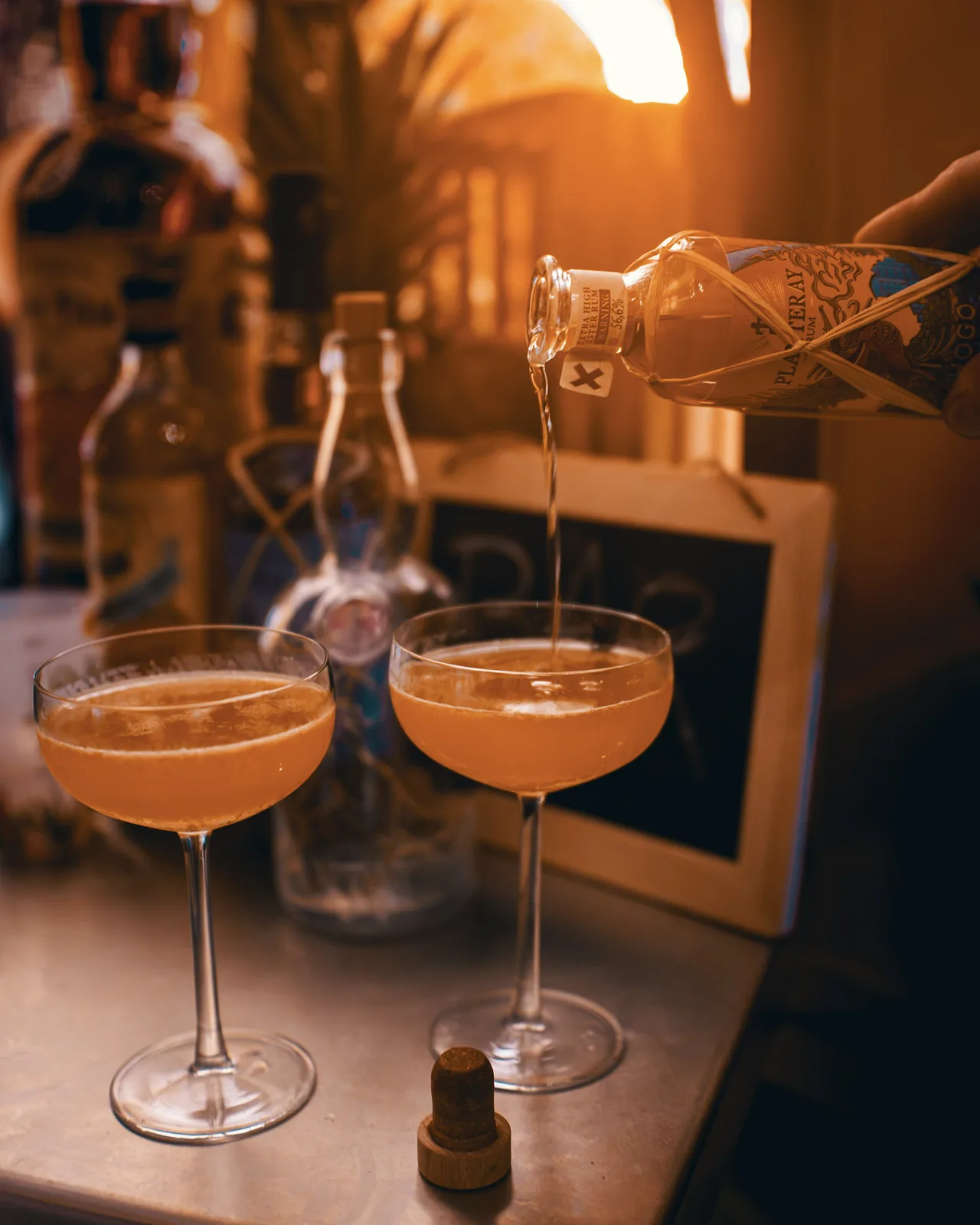 Pouring Planteray Hogo Monsta extra high ester rum, 56.6%, over two Daiquiris in coupes at The Modern Alchemist, Brussels